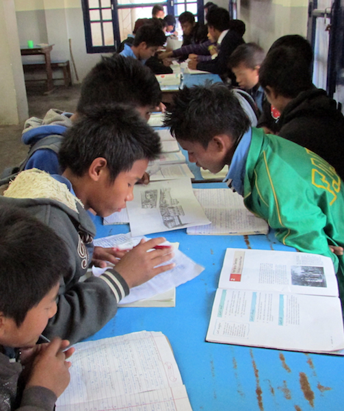children doing self study in dinning hall